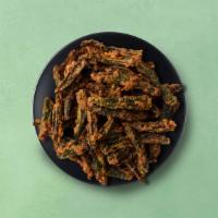 Okra Fry · Tender okra pods stir-fried with gram flour, onions, garlic, and aromatic spices. Served wit...