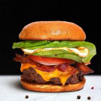 Breakfast Burger · American beef patty topped with bacon, fried egg, avocado, melted cheese, lettuce, tomato, o...