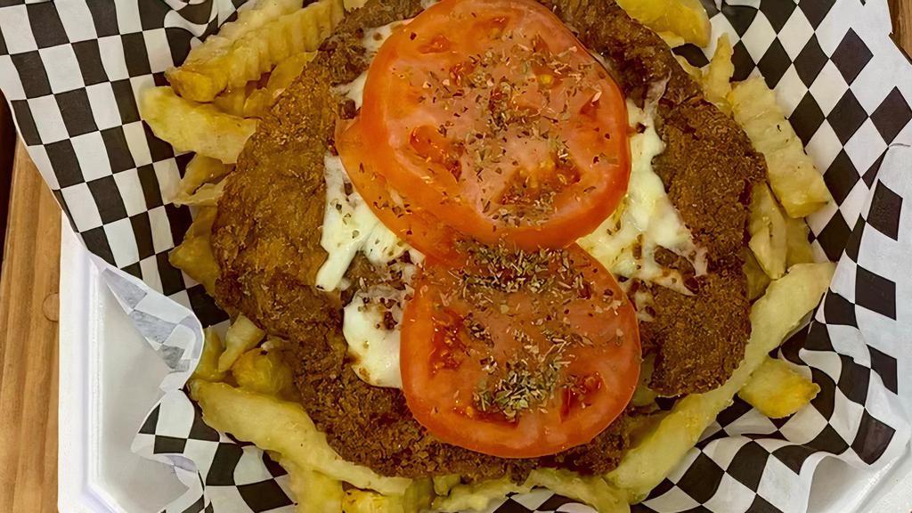 Argentina  Milanesa Napolitana With Fries · BEEF OR CHICKEN MILANESA , MELTED MOZZARELLA CHEESE OVER A MARINARA SAUCE, SLICED HAM AND FRESH TOMATOES WITH FRENCH FRIES.