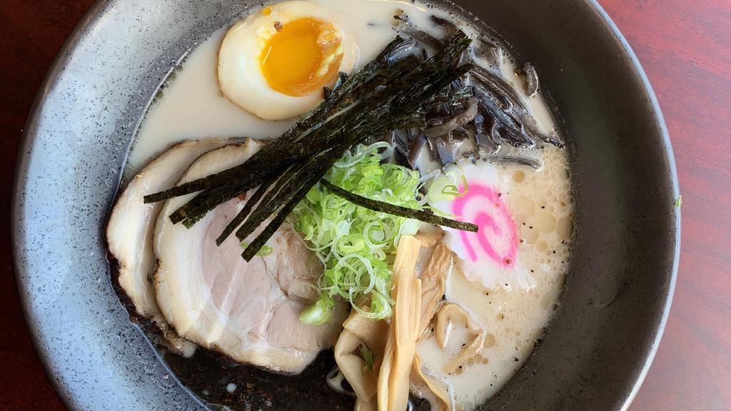 Tonkotsu Ramen · Thin noodles in our special rich, milky, chicken and pork bone broth topped with braised pork belly, scallions, bamboo shoots, kikurage mushrooms, fish cake and half boiled egg.