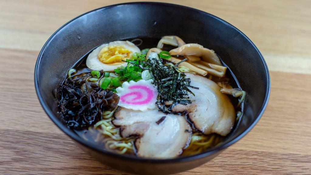 Shoyu Ramen · Wavy noodles in our special shoyu broth topped with braised pork belly, scallions, bamboo shoots, kikurage mushrooms, fish cake and half boiled egg.