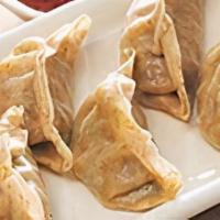 Veg Dumplings · Steamed minced vegetables tossed with onions and served with soy sauce.