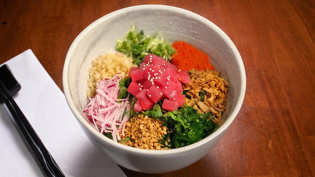 Crunch Poke Bowl · Tuna and salmon, seasoned rice, kale, caviar, seaweed salad, daikon cress, red radish, assorted crunches.