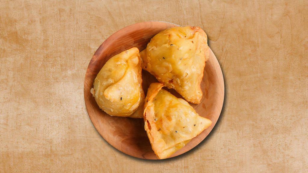 Downtown Samosa · 2 pieces. Fried pastry with an amazing filling of potato and peas. Served with mint-cilantro and date-tamarind relish.