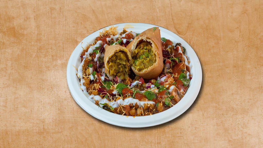 Samosa Reloaded · Authentic samosa smashed and topped with yogurt, mint, and tamarind sauce and sprinkled with savory gram flour sprinkles.