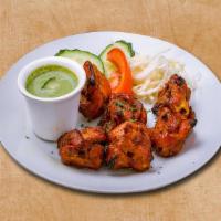 Chicken Triumph · Chicken pieces marinated with spices and yogurt and grilled in Indian clay oven.