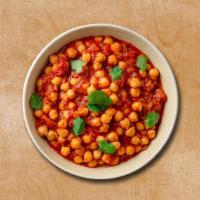 Courtyard Chickpea Masala · Chickpea is cooked with different spices and herbs and veggies. Served with a side of our ar...
