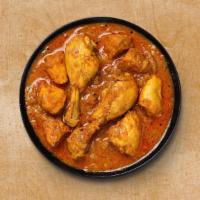 Classic Chicken Curry · Chicken simmered in a curry sauce with yogurt, tomatoes, onion, garlic, and ginger. Served w...