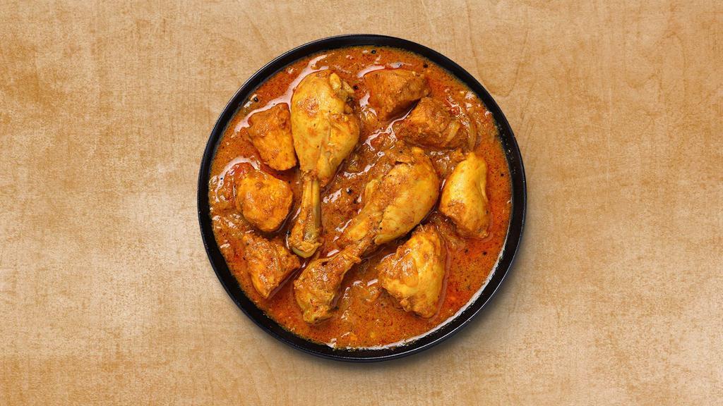 Classic Chicken Curry · Pieces of tender chicken are prepared in tomato sauce and cream with Indian spices. Served with a side of our aromatic basmati rice.