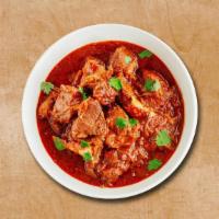 Lamb Maverick · Tender lamb pieces cooked in curry with chopped onions, tomatoes and spices. Served with a s...