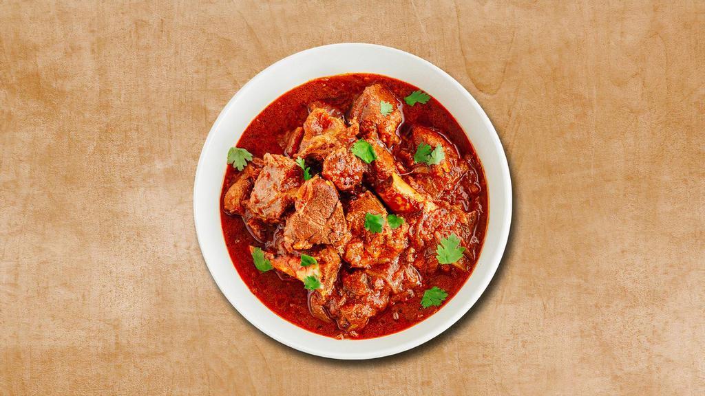 Lamb Maverick · Tender lamb pieces cooked in curry with chopped onions, tomatoes and spices. Served with a side of our aromatic basmati rice.