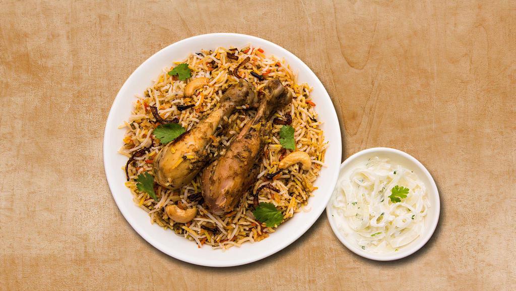 Chicken Biryani Theory · Aromatic rice cooked with chicken tenders, Indian spices, and herbs. Served with lightly spiced curry and raita.
