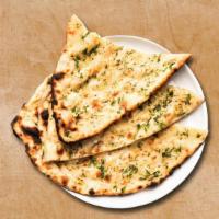 Garlic Naan · Freshly made dough and stuffed with garlic baked in an authentic Indian oven.