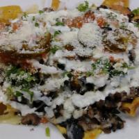 Meat Nachos 86 · Meat, beans, crema, melted Monterey cheese, pico de gallo, and cilantro.