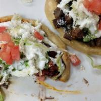 Sopes · Sope only. Two thick homemade corn tortillas, beans, cream, Cotija cheese, tomato, and lettu...