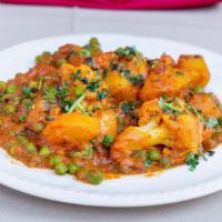 Aloo Muter Gobi Ala Carte · Vegetarian. Potatoes, peas and cauliflower, cooked with herbs and spices. Served with pillaw...