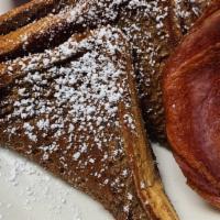 French Toast · 2 warm, cinnamon-y Texas toast slices topped with powdered sugar & served with table syrup