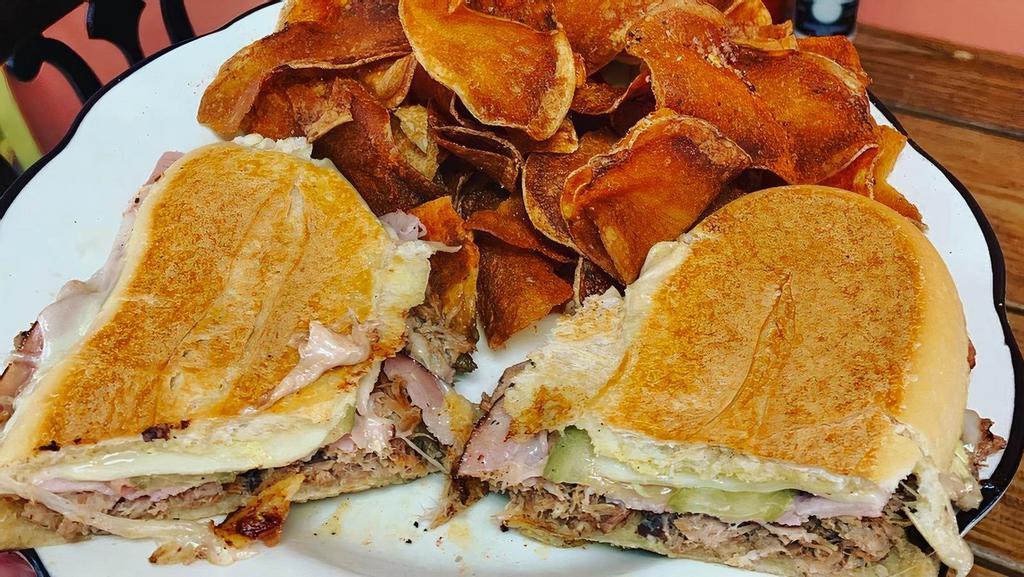 Cuban Sandwich · GRUB FAVORITE! Juicy house-made shredded mojo pork, sliced ham, Swiss, pickles, & housemade mustard aioli on a pressed sub roll.