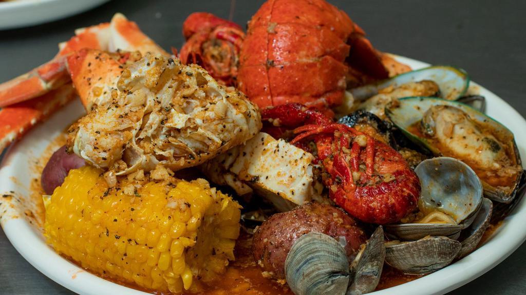 The Cajun Seafood Specialty · Seafood boil made exactly as you want it. Pick 3 seafood boil, tossed in flavorful seasoning and spice of choice. Served with 3 corn and 3 potatoes. Option to add more items.