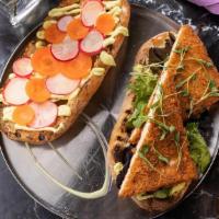 Lemongrass Chick'N Sandwich · crispy tofu chick’n, pickled radish & carrot, lemongrass mayo, cilantro, field greens