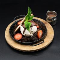 Chocolate Earthquake Cake · triple dark chocolate crumble coated in chocolate fondue, hazelnut sauce, w/ hazelnut ice cr...