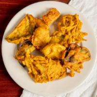 Mixed Vegetable Pakora · Vegetables fritters made from spinach onion, potatoes and spices.
