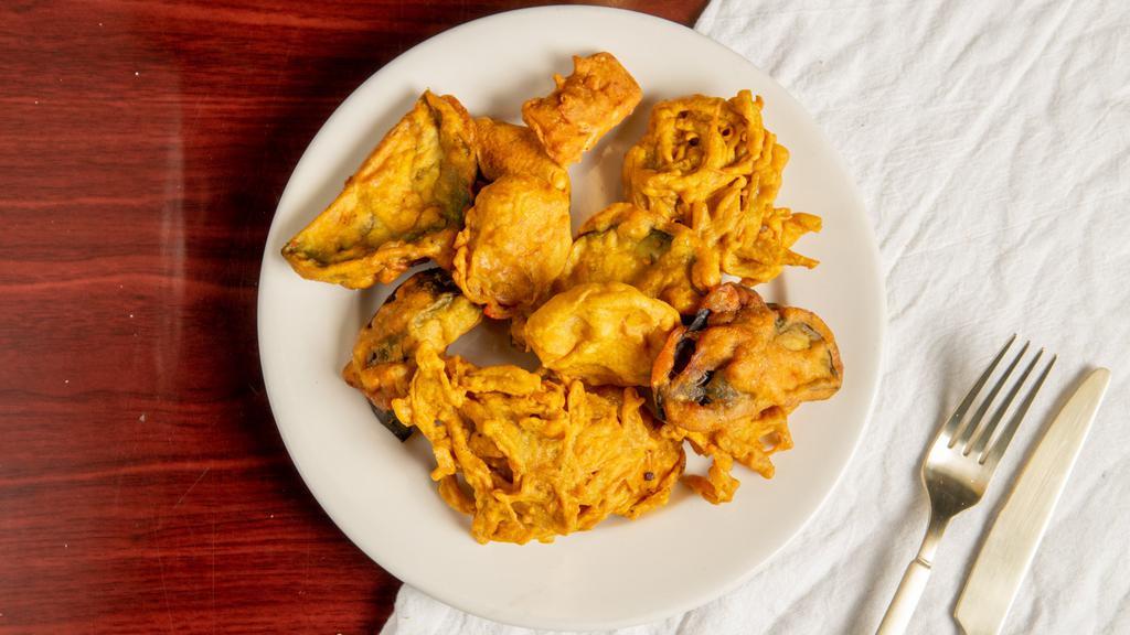 Mixed Vegetable Pakora · Vegetables fritters made from spinach onion, potatoes and spices.