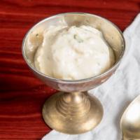Rasmalai · Cheese balls in a creamy milk sauce sprinkled with pistachio.