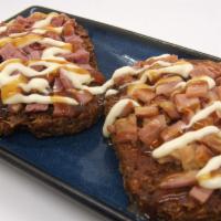 Fritter From The Land · 2 potato fritters topped with meat of your choice and crunchy onion.