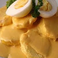 Papa A La Huancaina · Potatoes covered with huancaina creamy sauce.