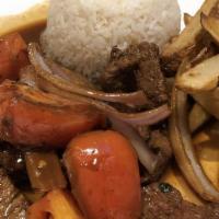 Lomo Saltado · Sirloin strip steak, sautéed tomatoes, and onions, served with homemade fries and parboiled ...