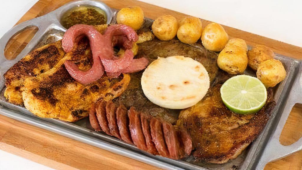 Parrillada Milina · Grilled beef, grilled chicken, grilled pork, chorizo, arepa, Colombian potatoes, and sausage.