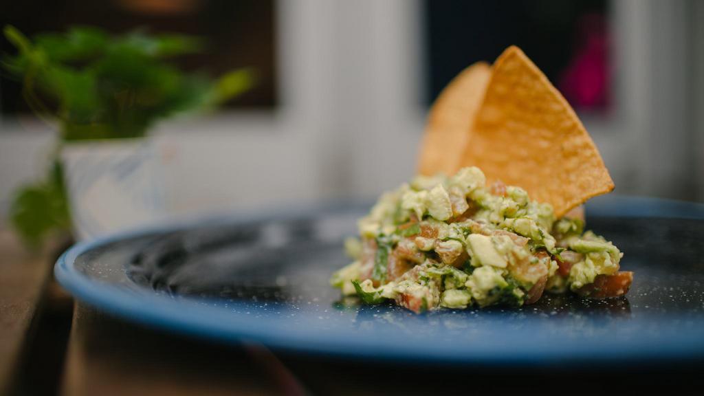 Guac & Chips · MADE FRESH with avocado, tomato, jalapeños, spices and lime. Served with fresh tortilla chips.