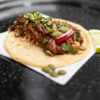 Mole Taco · Corn Tortilla with mole, a traditional sauce with a touch of sweetness, made with chocolate,...