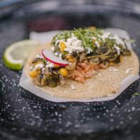 Rajas Con Queso Taco · Corn Tortilla with charred poblano peppers, a mild green chile, mixed with onion and corn in...