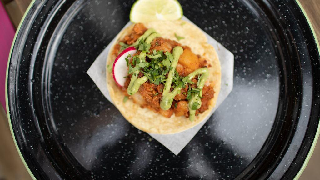 Potato & Soy Chorizo Taco · Corn Tortilla with vegans in mind, soy chorizo mixed with potatoes, blend of spices and LOVE!  . Topped with avocado sauce, radish, cilantro and lime
