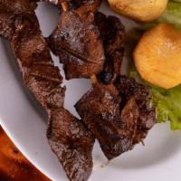 Anticuchos · Three delicious grilled beef skewers glazed with our famous Parrilla sauce and served with f...