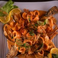 Pargo A Lo Macho (Red Snapper) · A whole red snapper with creamy calamari, mussels, shrimps, and crab seafood sauce on top. A...