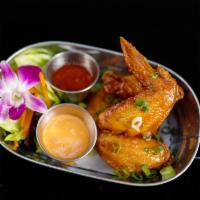 Thai Chicken Wings · Crispy chicken wings tossed in the wok with sweet chili sauce.