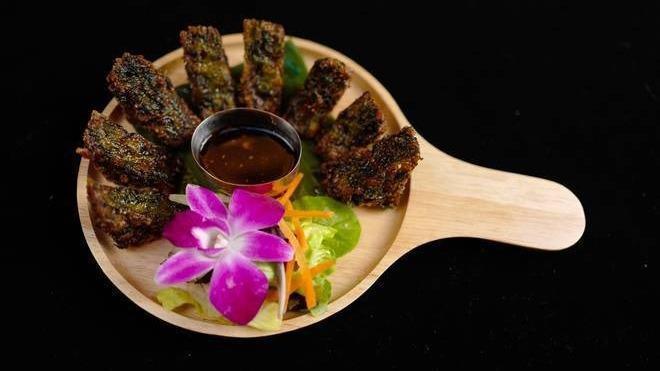 Kui Chai · Fried chive vegetable dumpling with Thai dipping sauce.