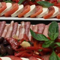 Cold Antipasto · Italian appetizer with lettuce and tomato with mixed cold cuts including salami, ham & provo...