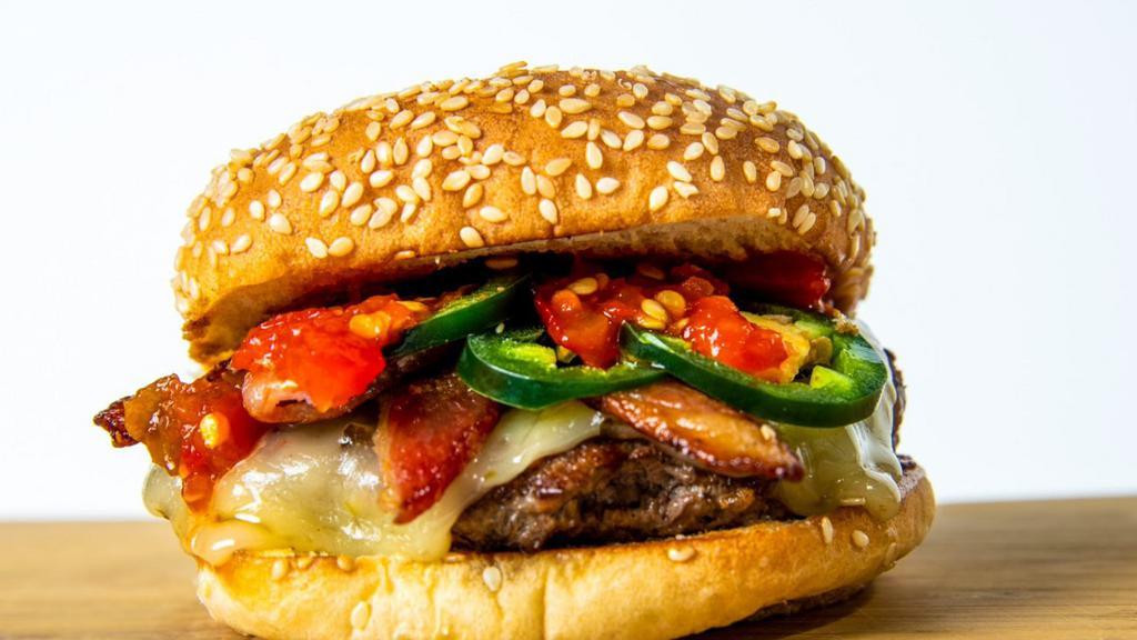 The Jalapeño · Pepper Jack cheeseburger,smoked bacon, jalapeños, house sauce, pickled spicy peppers and pickles.