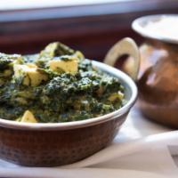 Palak Paneer · Homemade cheese simmered in creamy fresh spinach puree and garnished with chopped cilantro a...