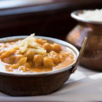 Chana Massala · Chickpeas cooked with ginger, onion, tomatoes, and herbs.
