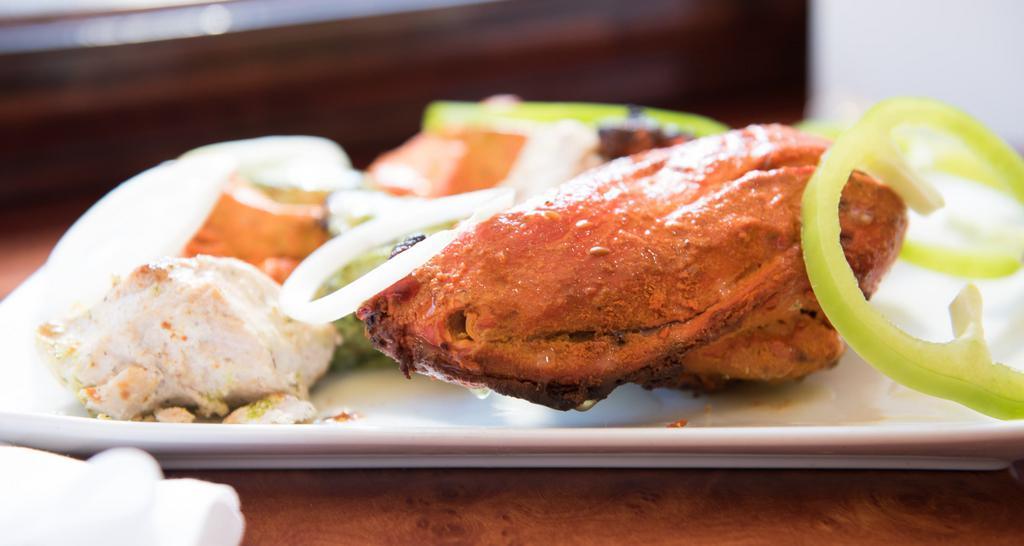 Tandoori Chicken · Chicken marinated in yogurt, ginger, garlic, and broiled in our charcoal clay oven.
