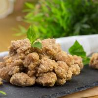 Popcorn Chicken · Bite sized, breaded, and fried chicken with Basil Leaves.