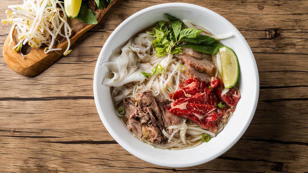 House Pho Noodle Soup · Comes with rare eye round, brisket, tripe and tendon, with rice noodles, served with beef broth, onions, scallions, and lemon, basil & bean sprouts on the side.