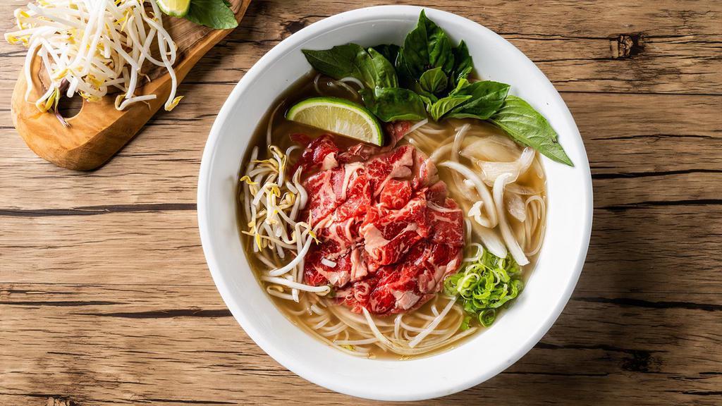 Classic Rare Beef Pho Noodle Soup · Rare beef with rice noodles, served with beef broth, onions, scallions, and lemon, basil & bean sprouts on the side.