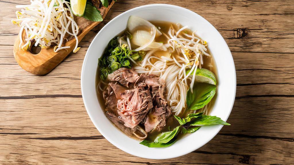 Cooked Beef Pho Noodle Soup · Cooked beef with rice noodles, served with beef broth, onions, scallions, and lemon, basil & bean sprouts on the side.