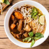 Beef Stew Pho Noodle Soup · Beef stew with rice noodles, served with spiced beef broth, onions, scallions, and lemon, ba...